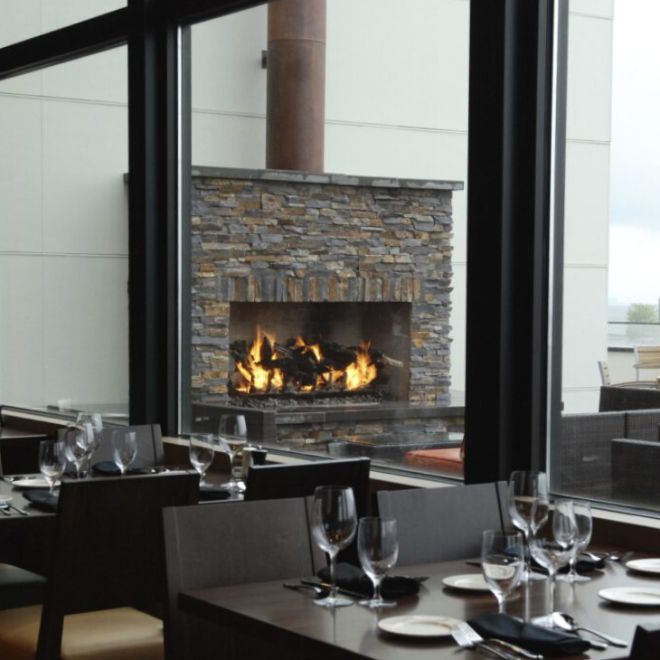 A restaurant with a fireplace in the background
