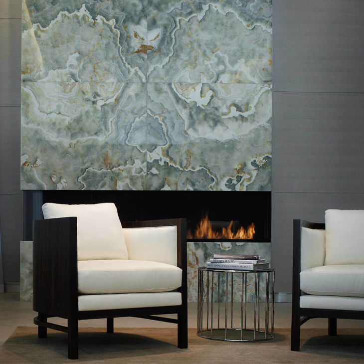 A living room with two chairs and a fireplace