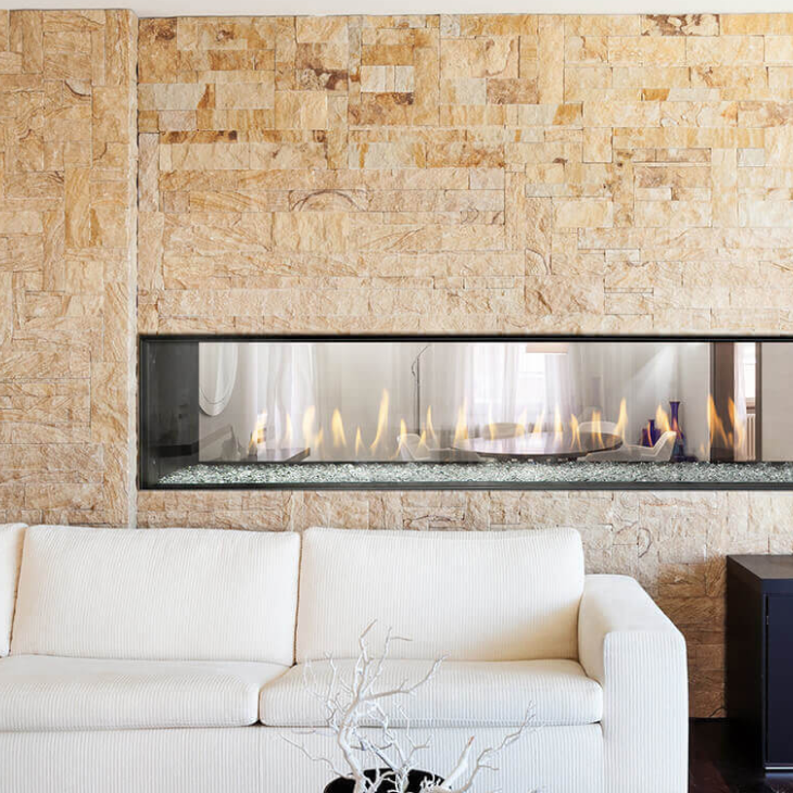 A living room with a fireplace and a white couch
