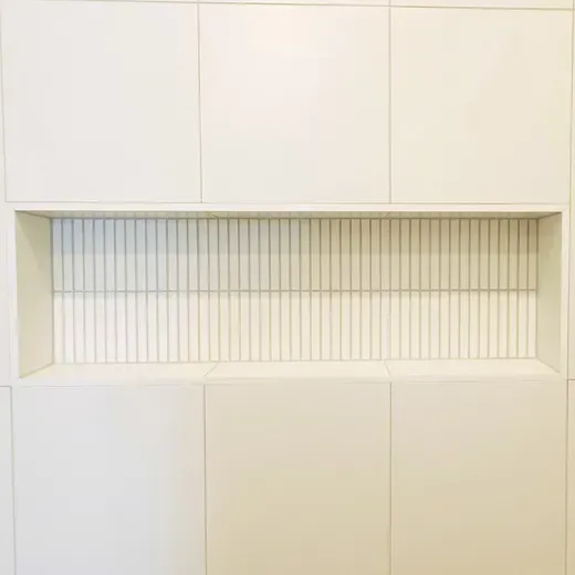 Minimalist white wall with a recessed horizontal slatted window panel