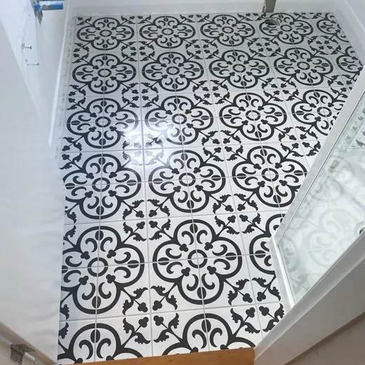 Black-and-white patterned tile floor in a small hallway or bathroom doorway