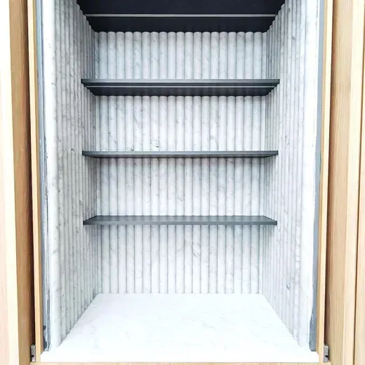 Empty white cabinet with four dark shelves and a striped back wall