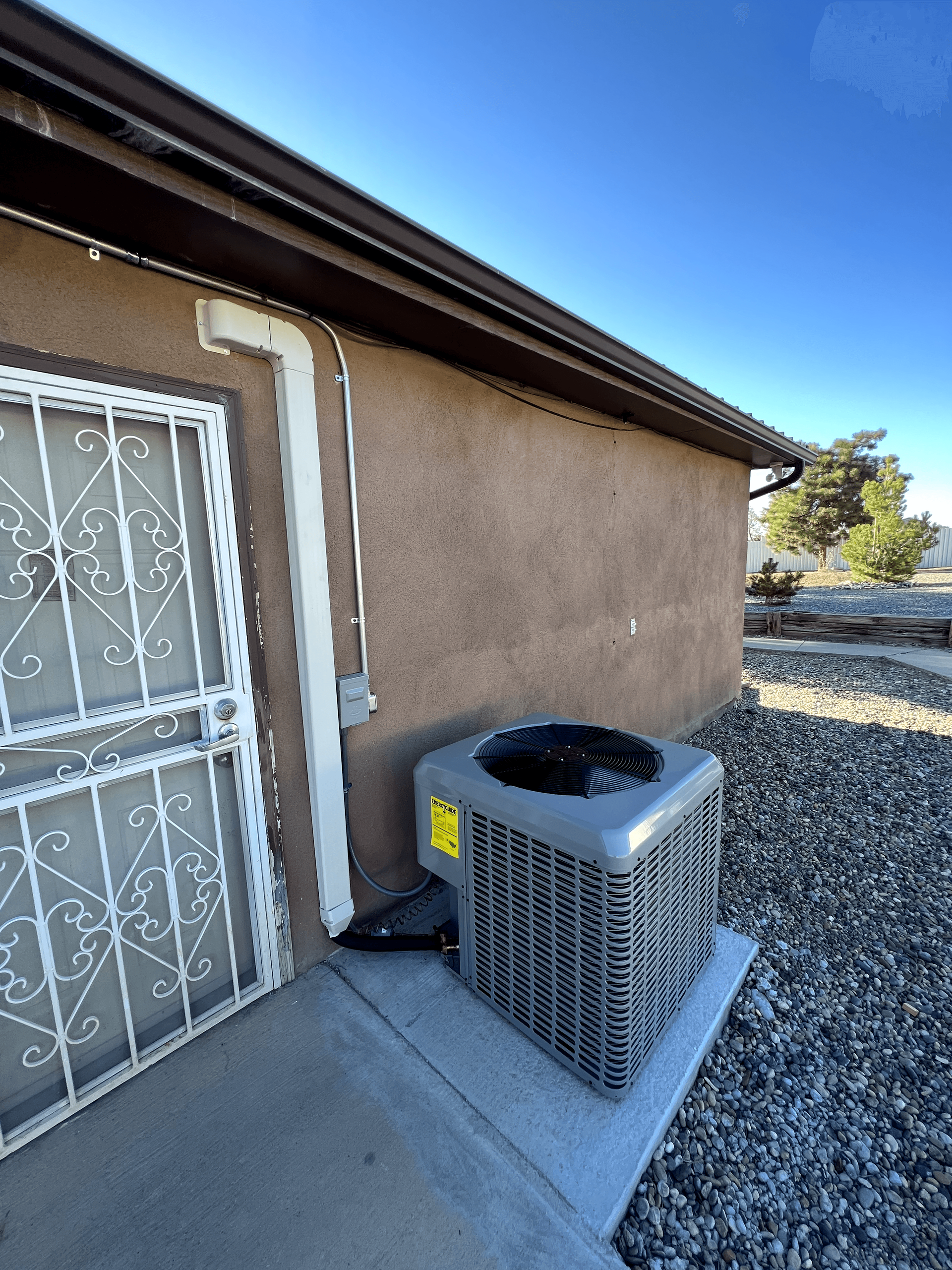 An air conditioner is sitting on the side of a building.
