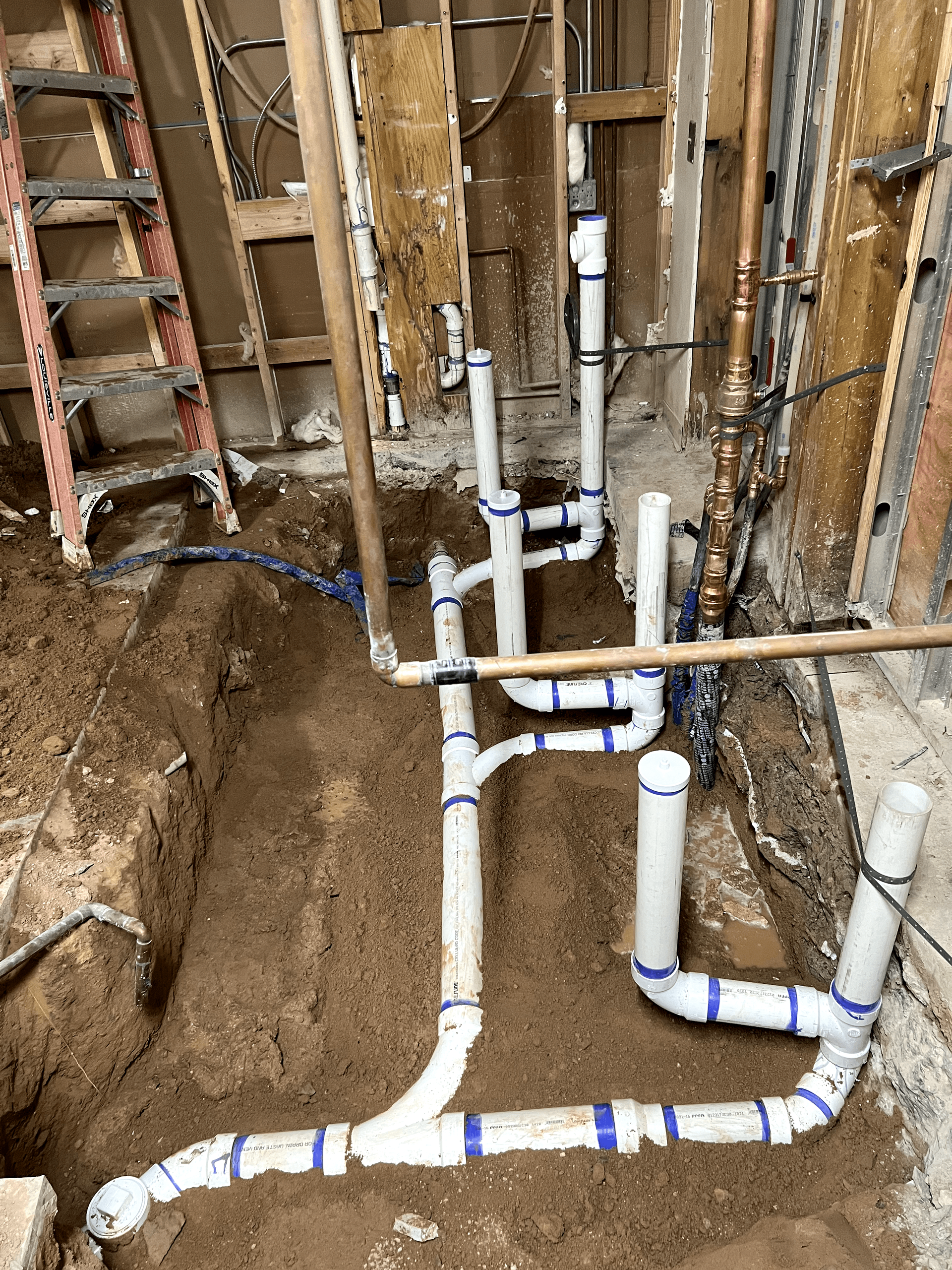 A bunch of pipes are being installed in a hole in the ground.