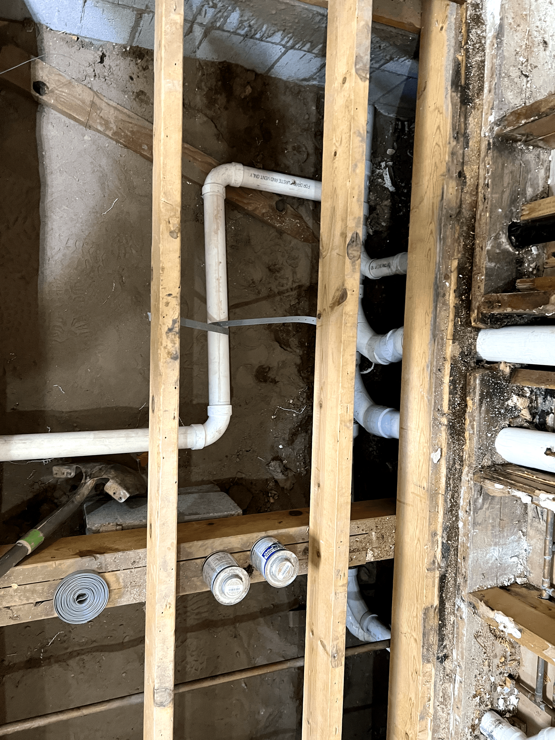 A bunch of pipes are hanging from the ceiling of a building.