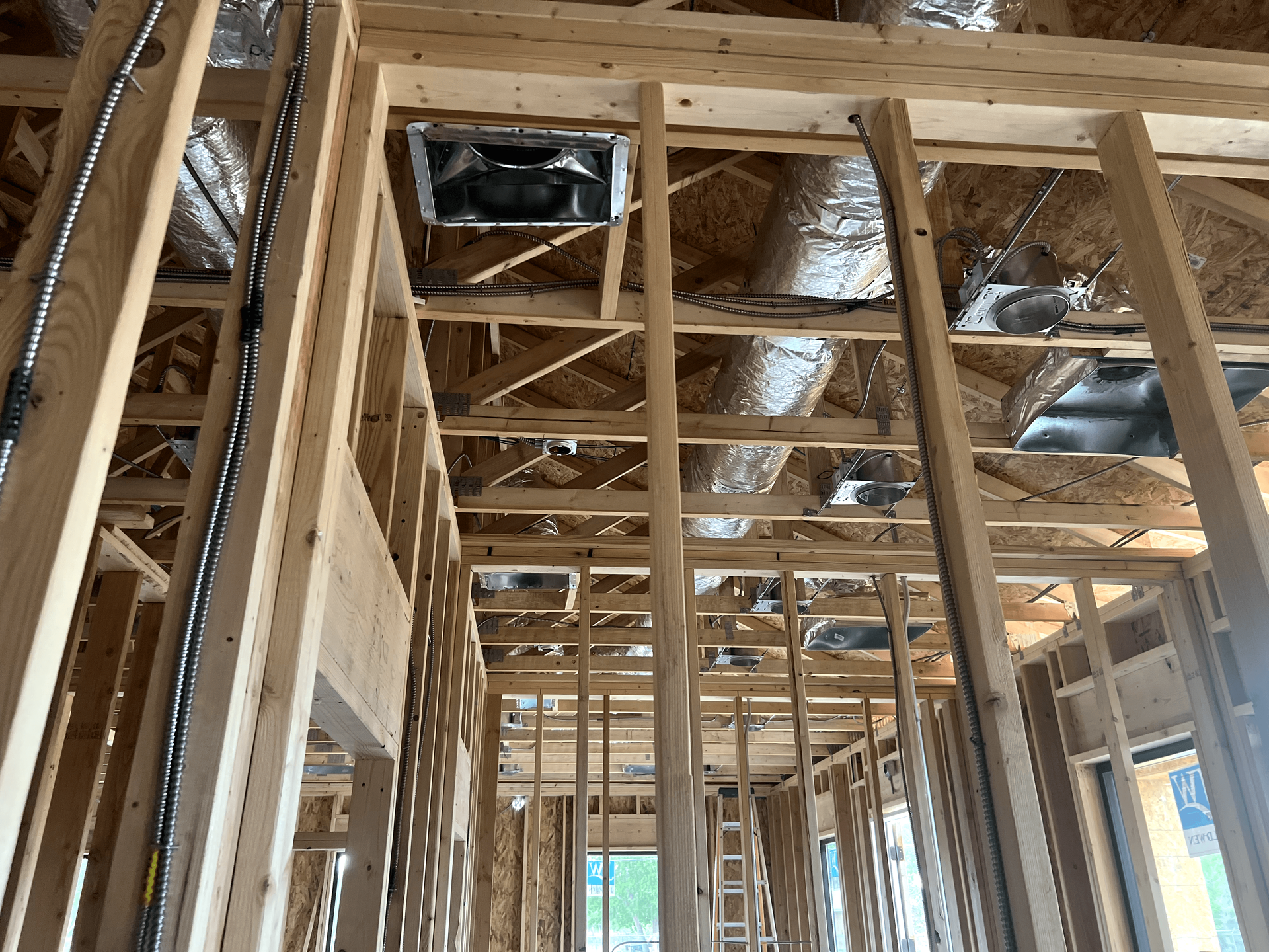 The inside of a building under construction with a lot of wooden beams.