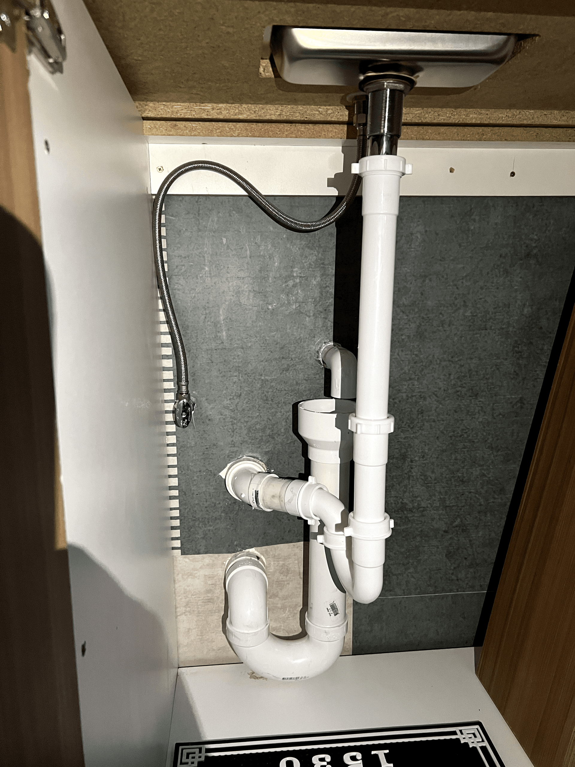 A bathroom sink with a hose attached to it