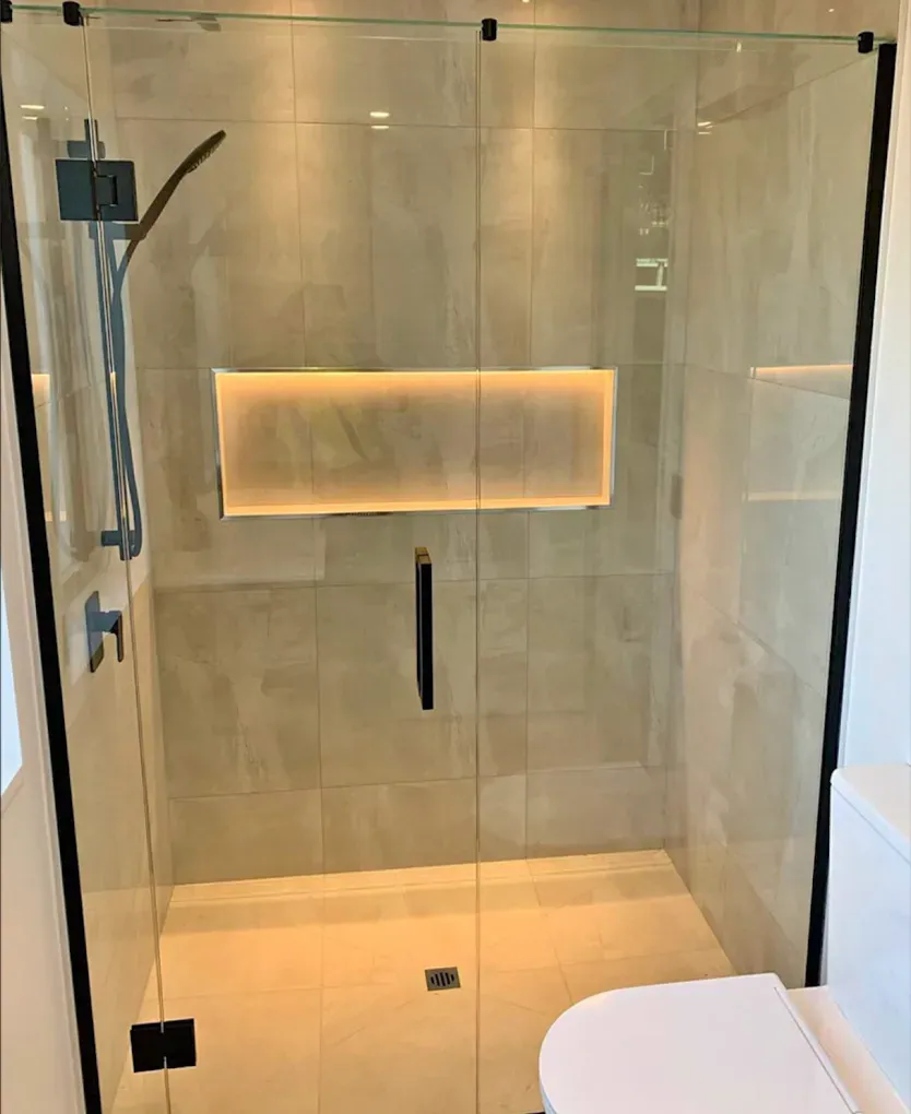 Custom Frameless Shower Door with Matte Black Hardware installed during a luxury condominium renovation in Brickell.