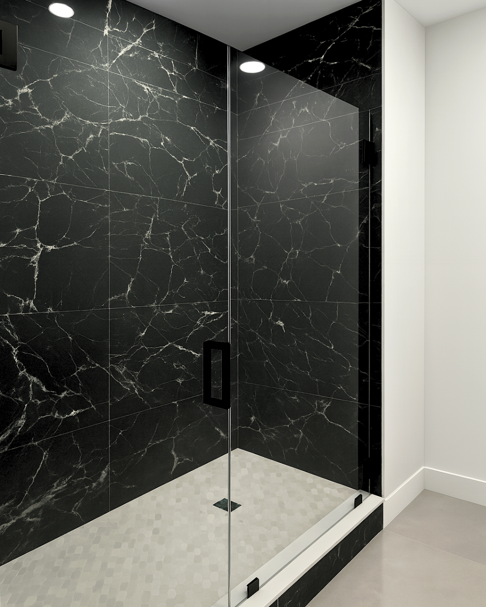 Black marble-tiled shower with a glass door and white trim, illuminated by overhead lights.