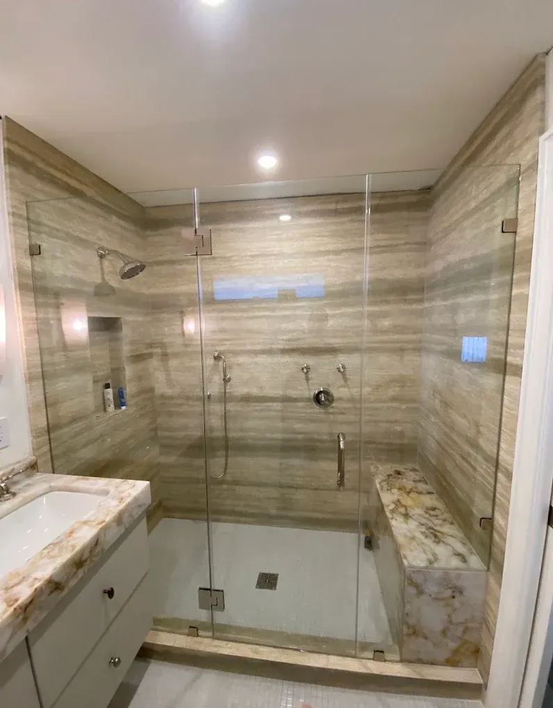 Custom Frameless Shower Enclosure fabricated and installed for a residential bathroom remodel in Kendall.