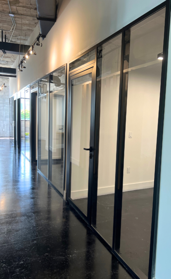 interior glass office door with black frame and handle.