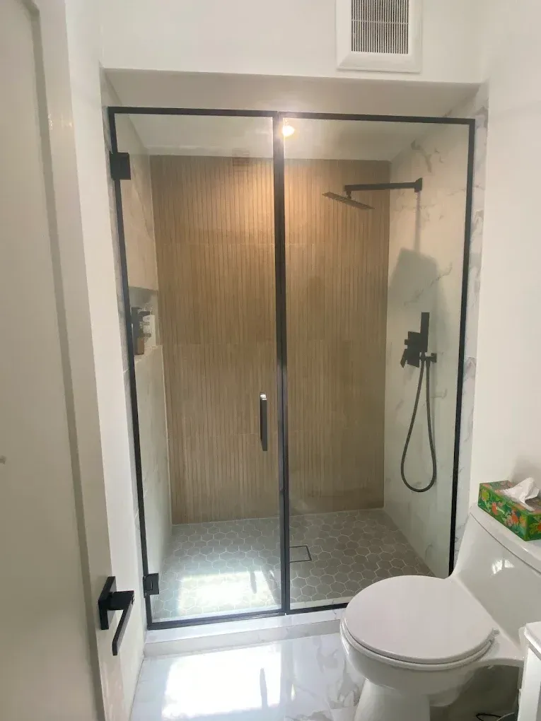 Black-framed shower glass door installation completed for a bathroom remodel in West Kendall.