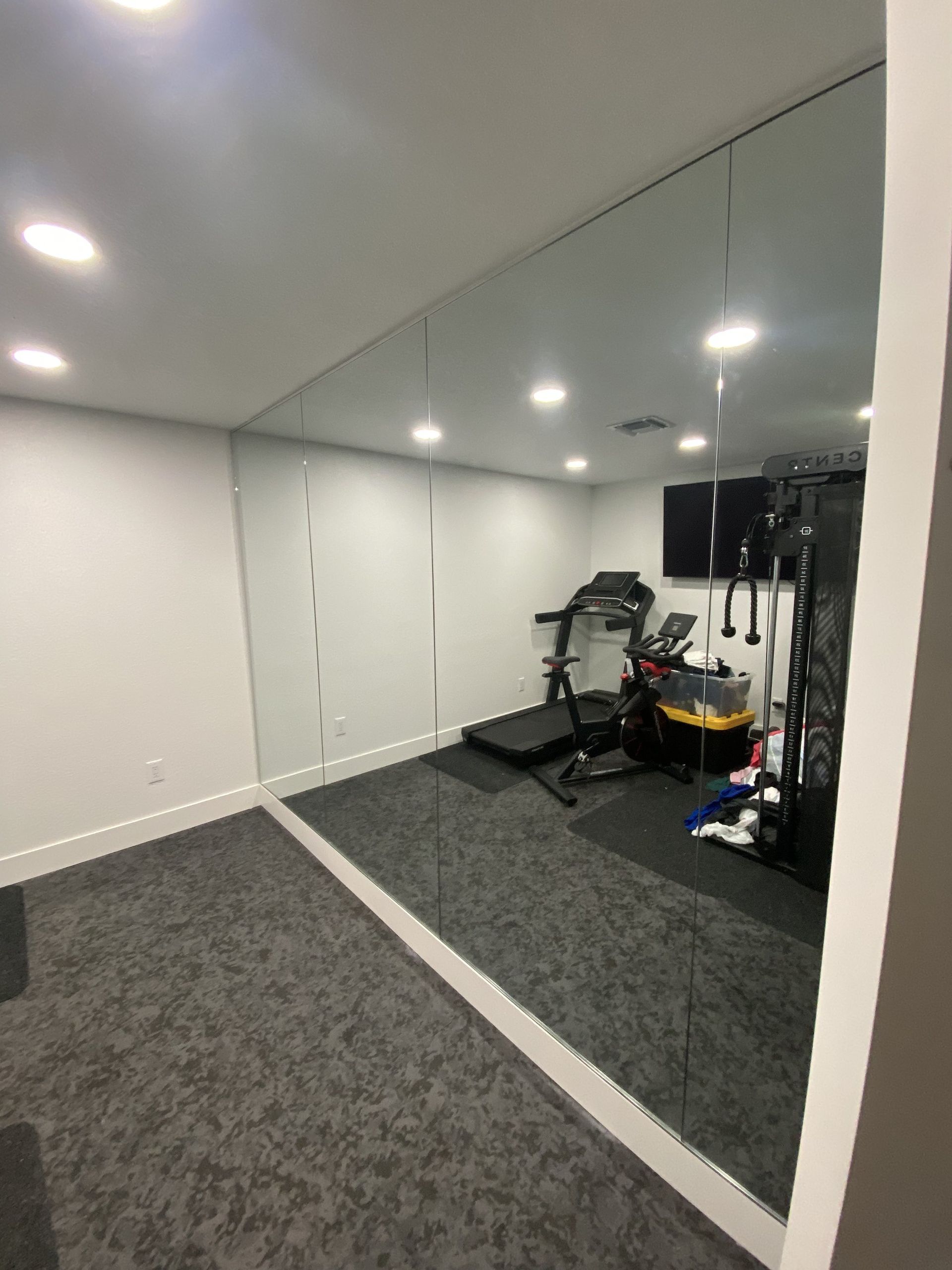 Floor-to-ceiling home gym mirror wall installed in Miami
