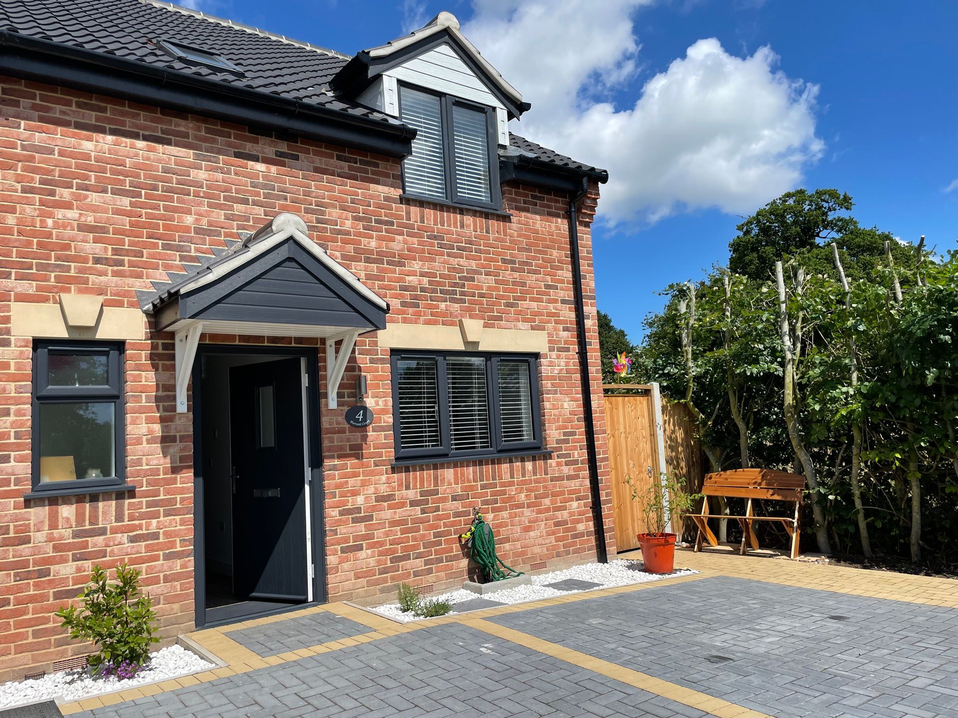 A brick house with a black door and black windows