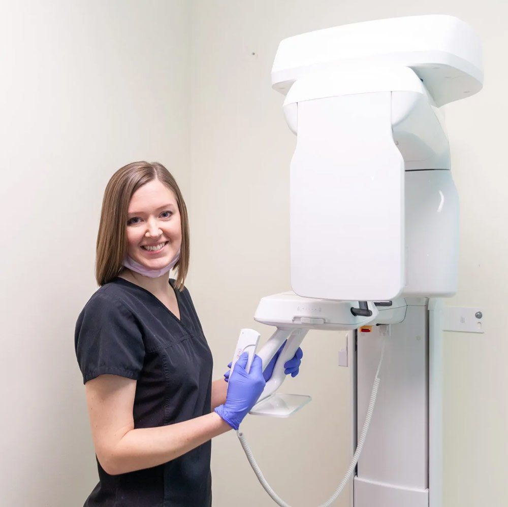 Dental Assistant learning to use X Ray machine
