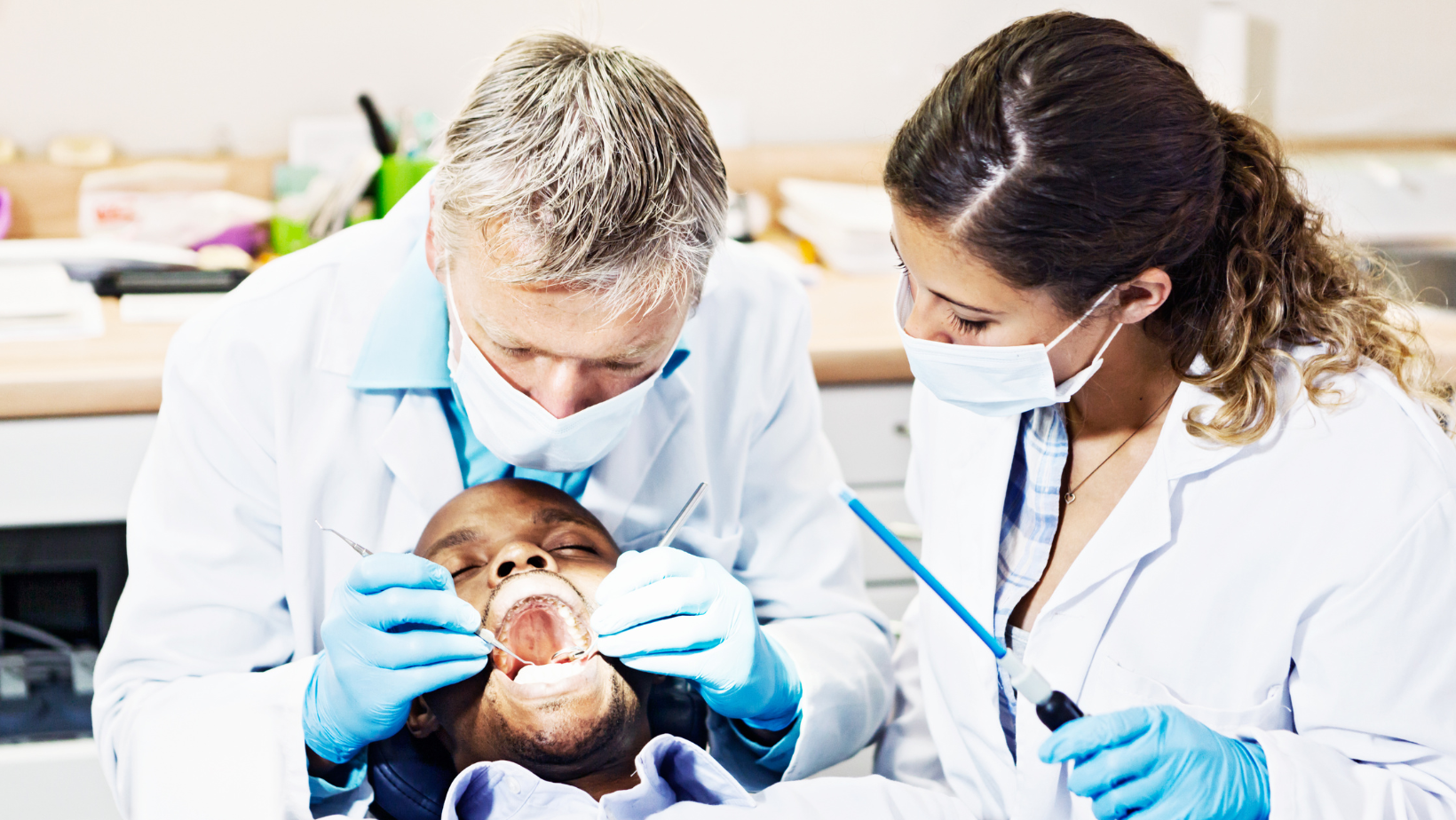 Dental Assistant Helping Doctor Examine patient