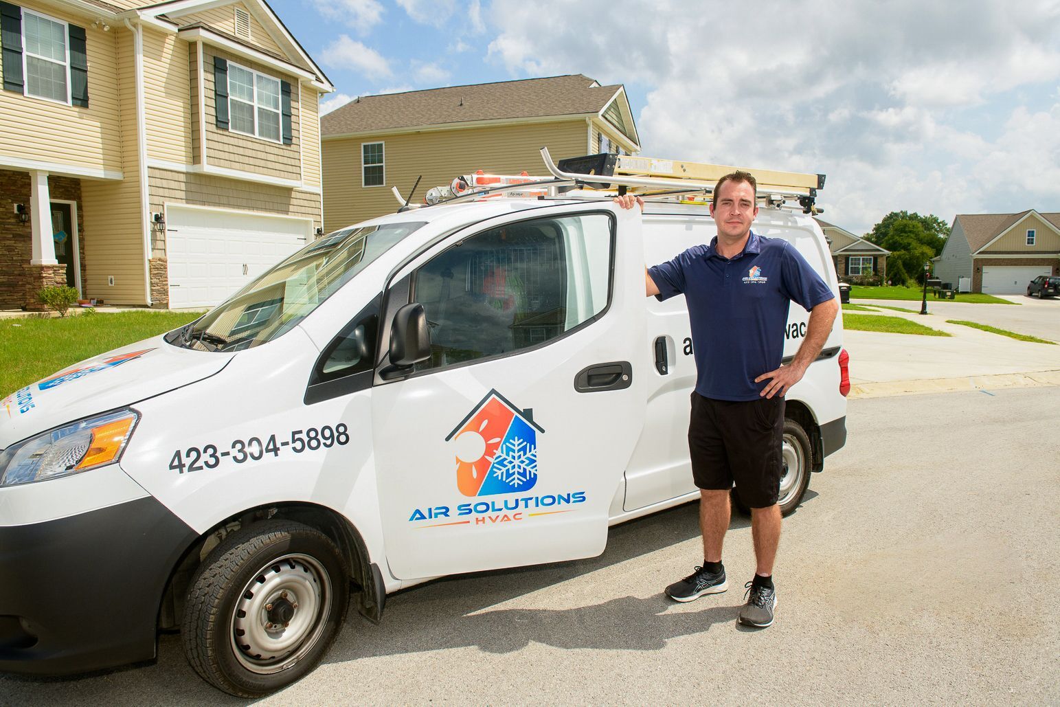 air solutions hvac business owner phillip williams standing next to his service vehicle