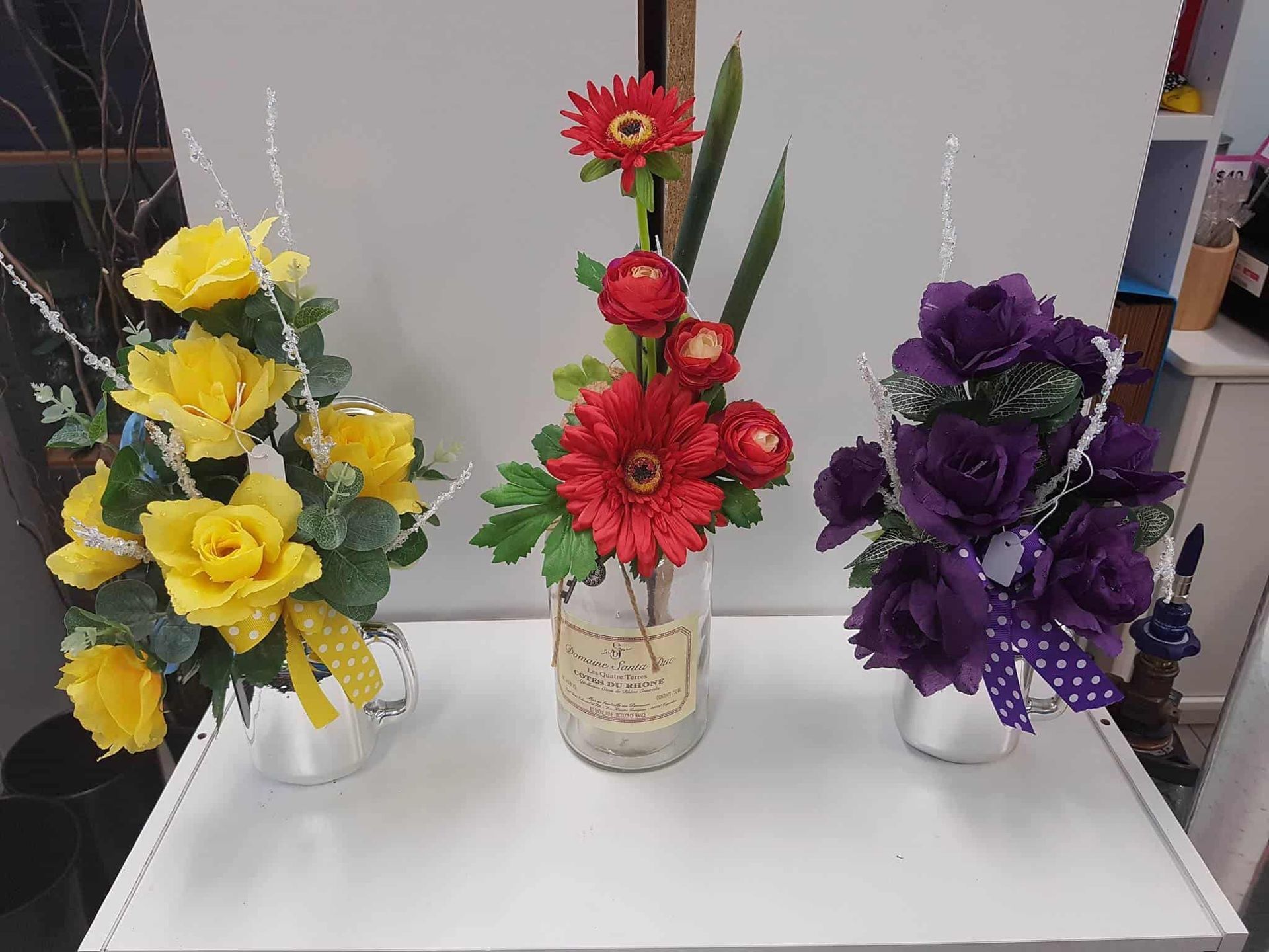 — The Flower Station Townsville In Kirwan, QLD Three Vases Filled With Flowers Are Sitting on a Table — The Flower Station Townsville In Kirwan, QLD