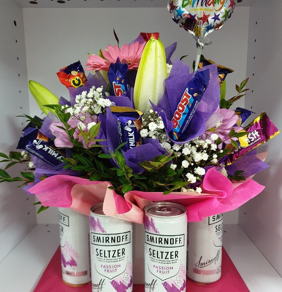 A Bouquet of Flowers is Sitting on a White Table — The Flower Station Townsville In Kirwan, QLD