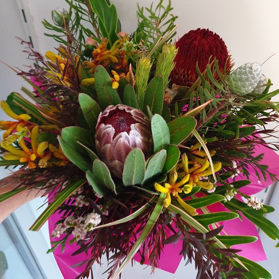 A Bunch of Vases Filled With Flowers Are Sitting on a Table — The Flower Station Townsville In Kirwan, QLD