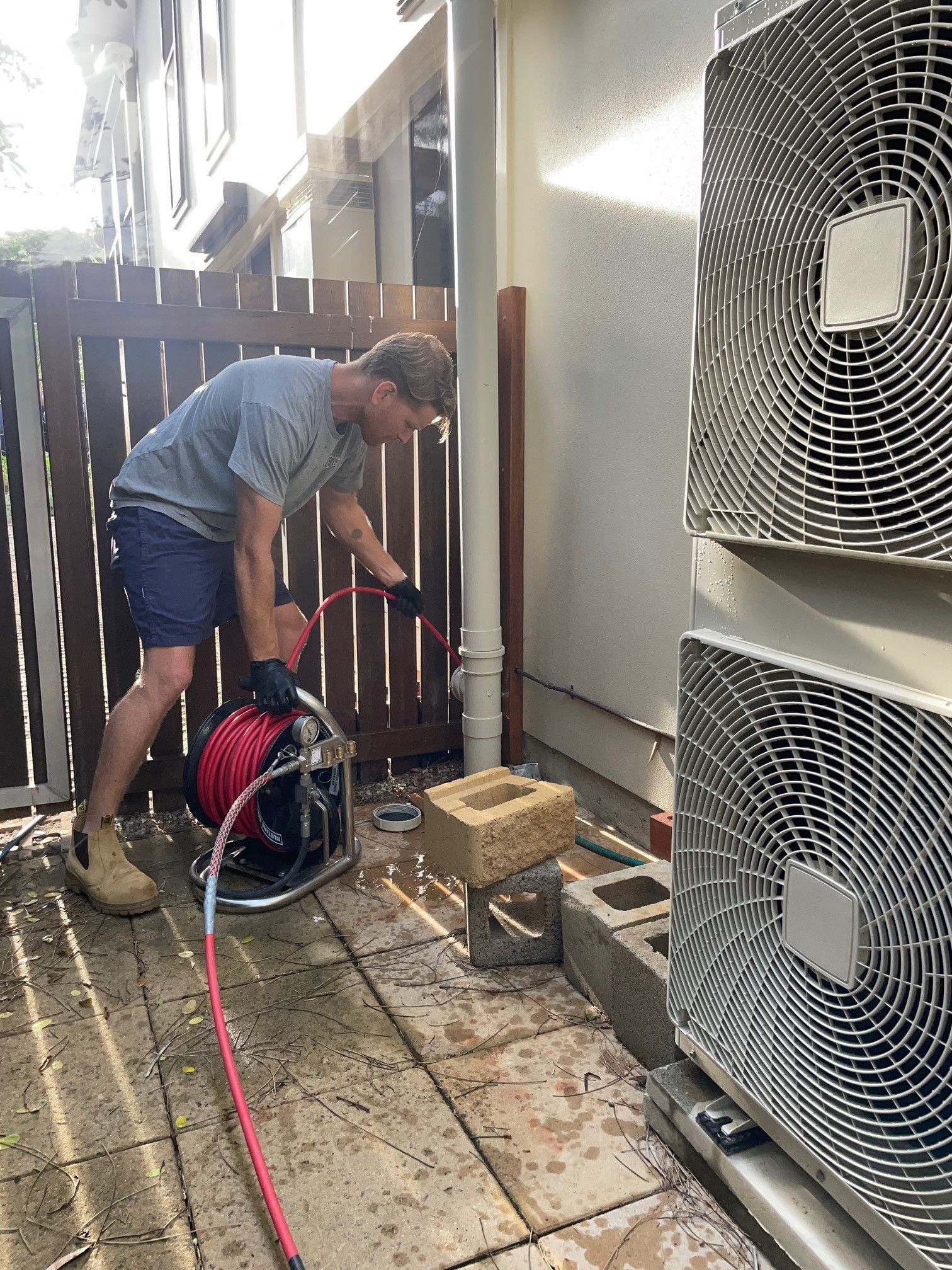Concrete Pad and Timber Edging Beside a Brick Wall — New Gen Plumbing and Gas in Banora Point, NSW