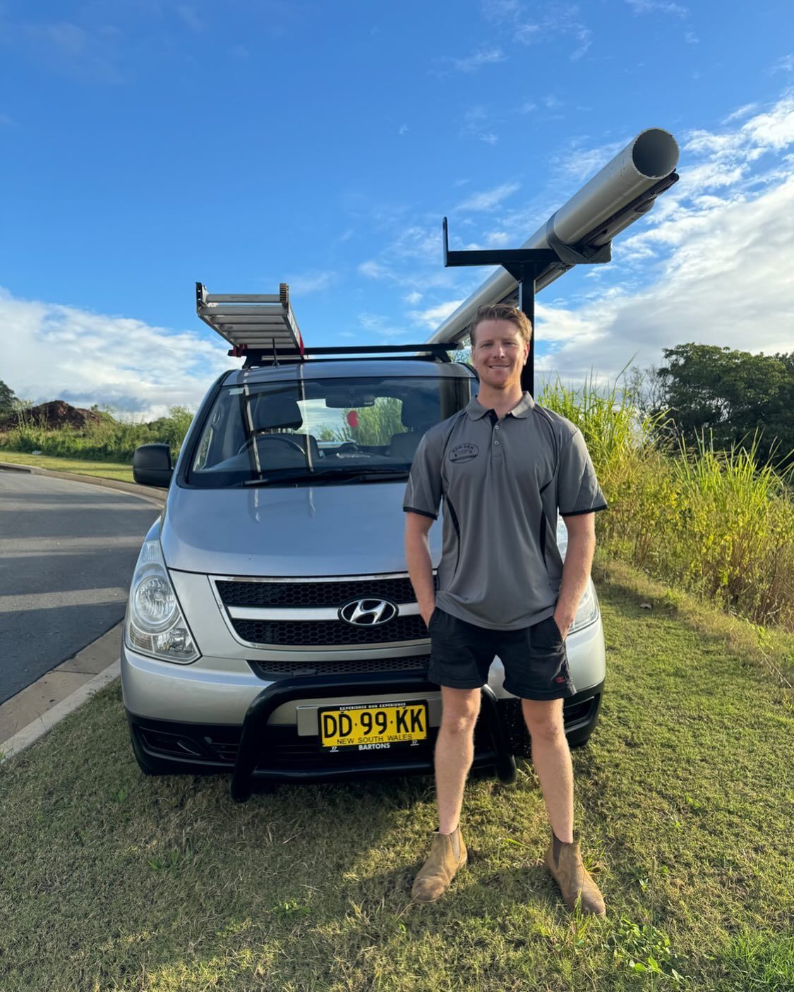 Man Standing Beside a Silver Van With Roof Racks on a Roadside — New Gen Plumbing and Gas in Banora Point, NSW