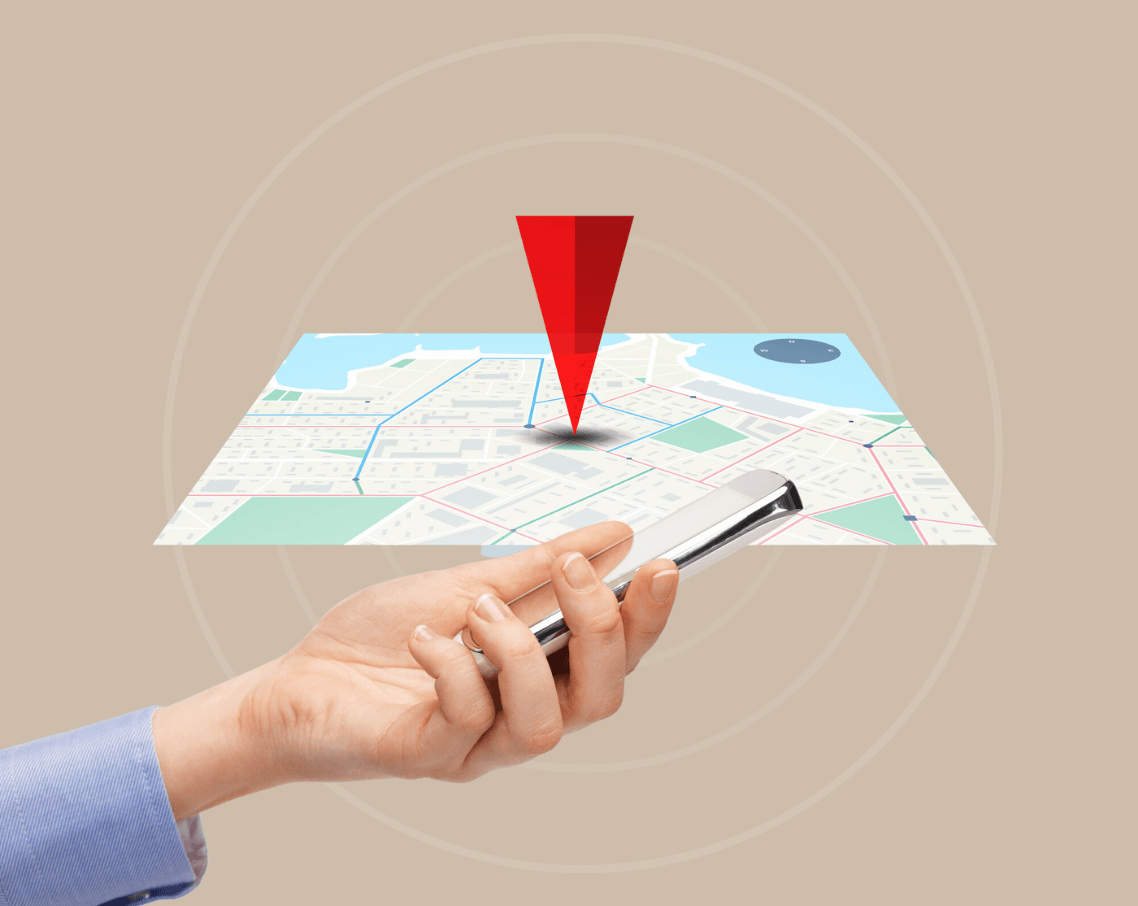 A person is holding a cell phone in front of a map.
