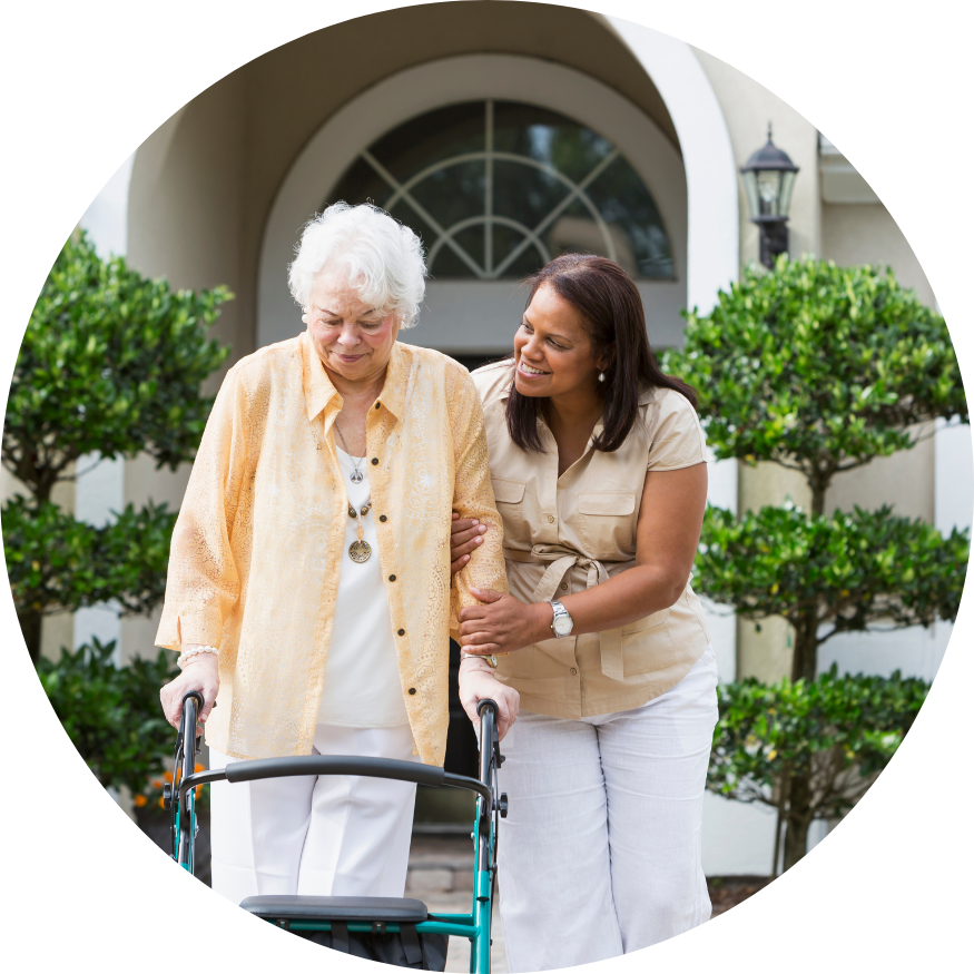 A woman is helping an older woman with a walker