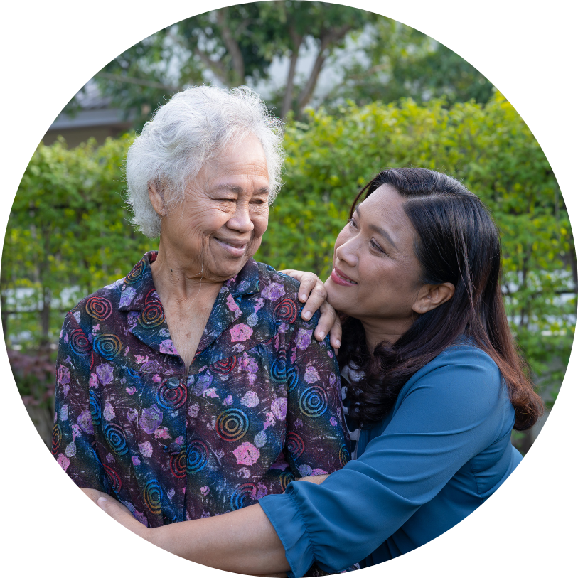 A young woman is hugging an older woman in a circle.