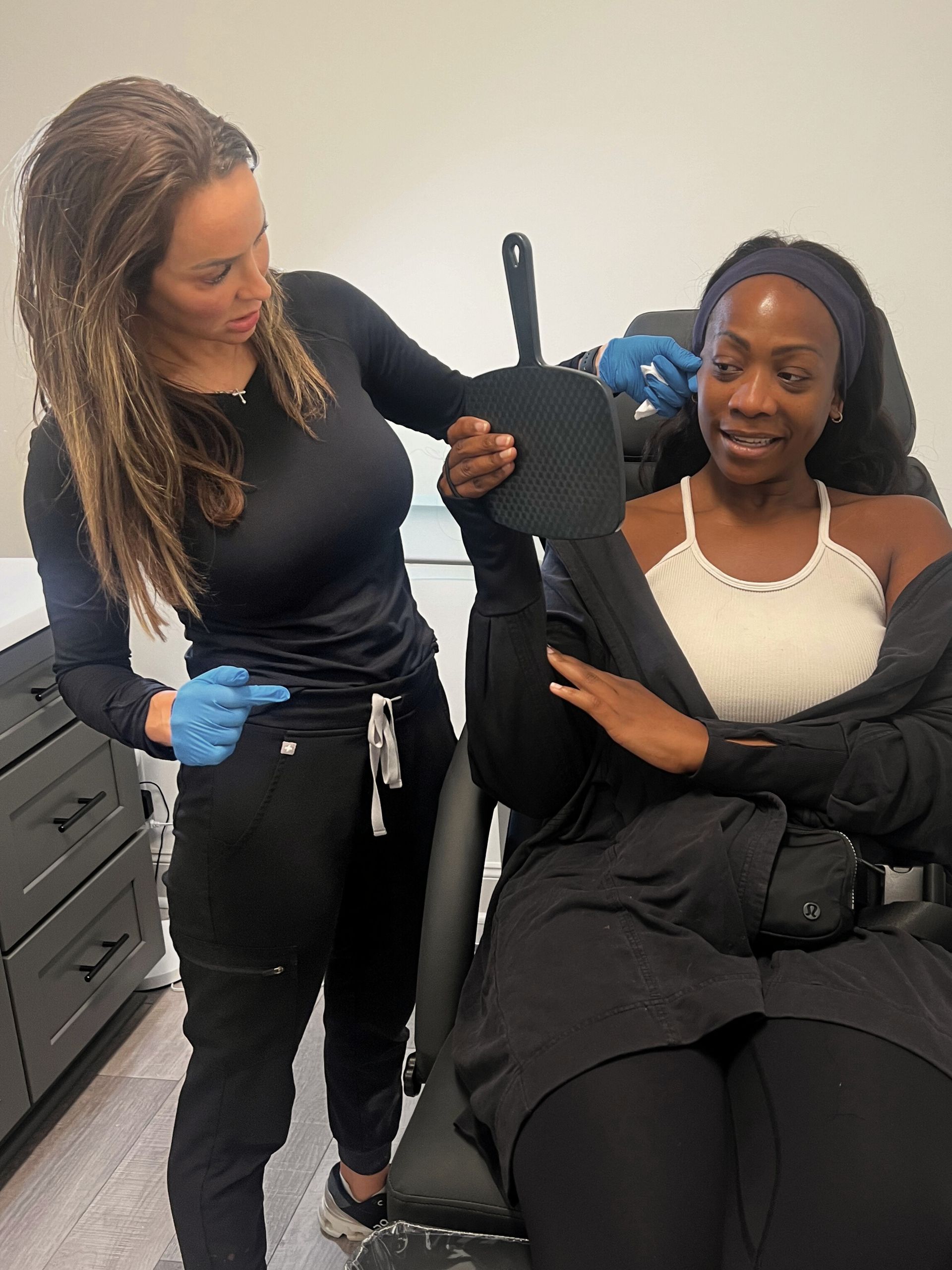 Crystal Fontenot consulting with a patient about wrinkle relaxer treatment in Lafayette, LA at Elle Medical & Aesthetics.