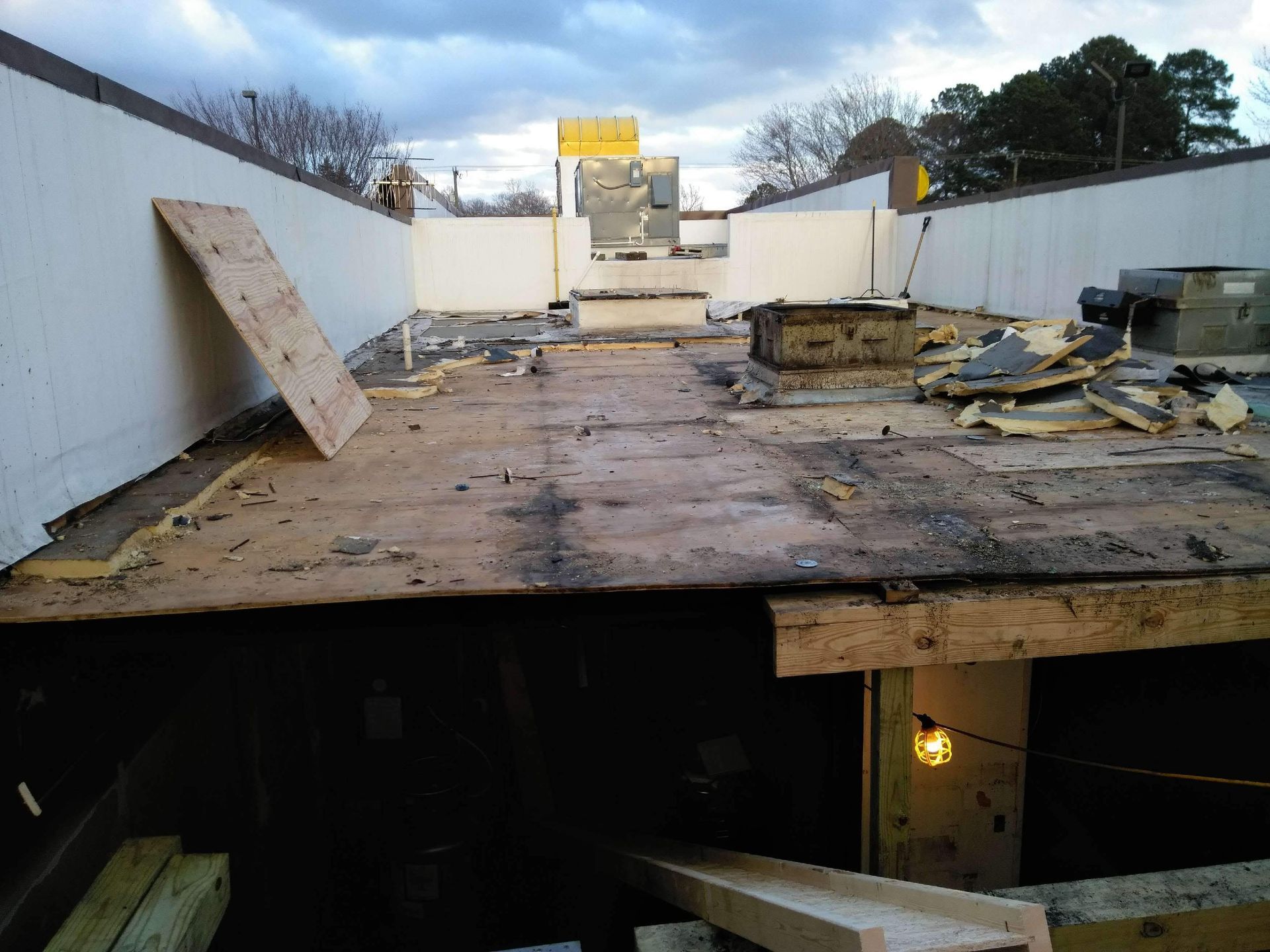 A roof that is being remodeled with a lot of wood on it