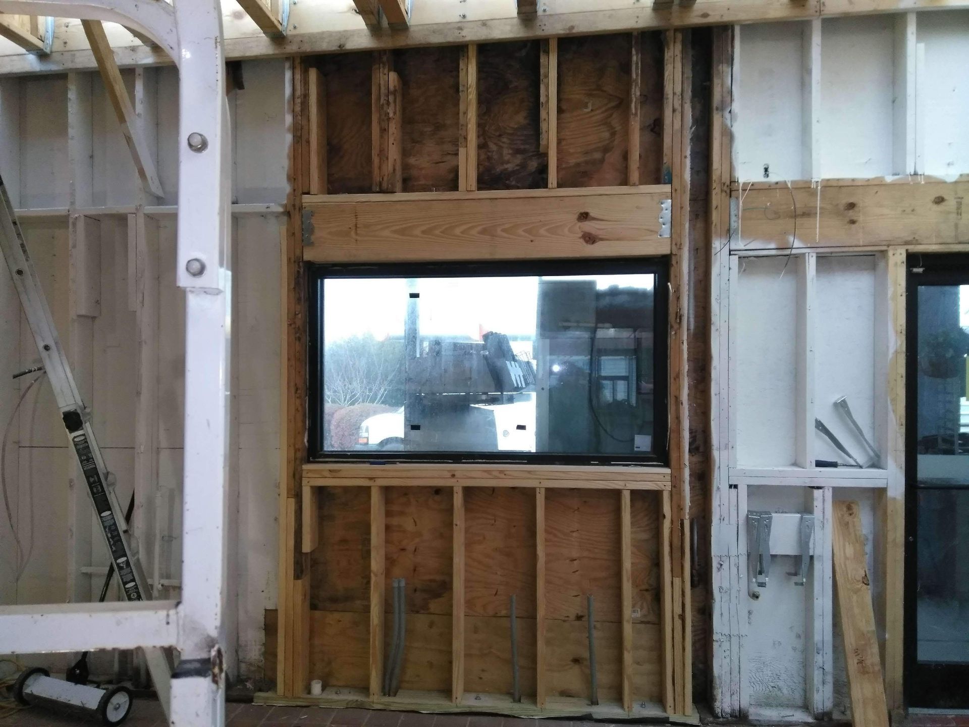 A building under construction with a large window in the middle