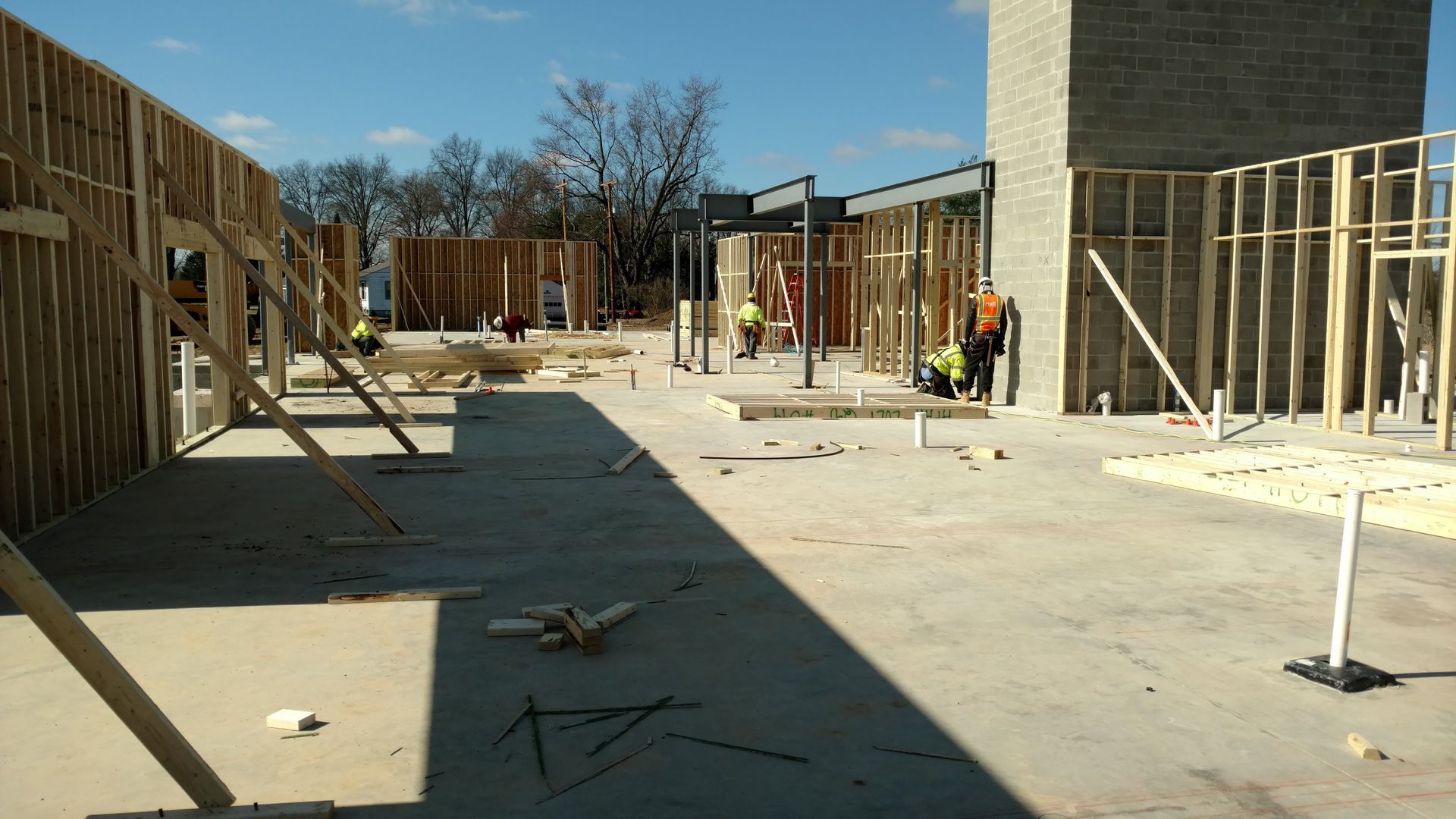 A group of construction workers are working on a building under construction