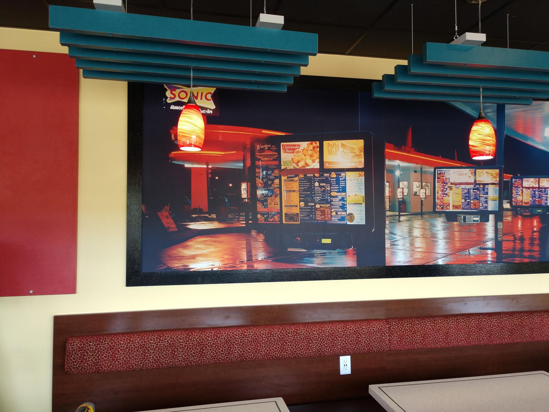 A sonic restaurant has a large picture on the wall
