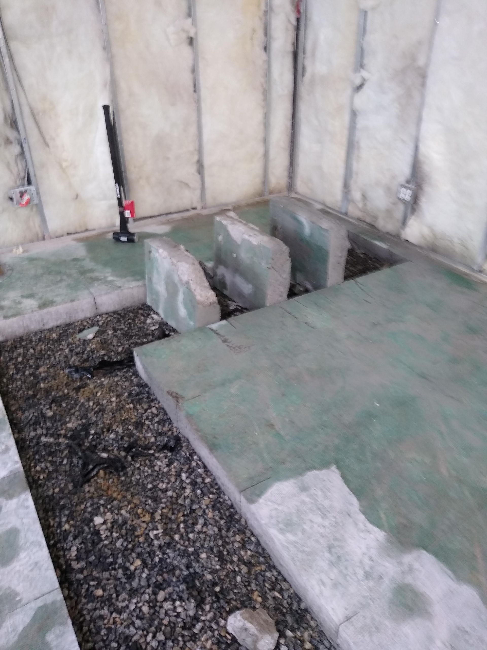 A concrete floor is being built in a room.