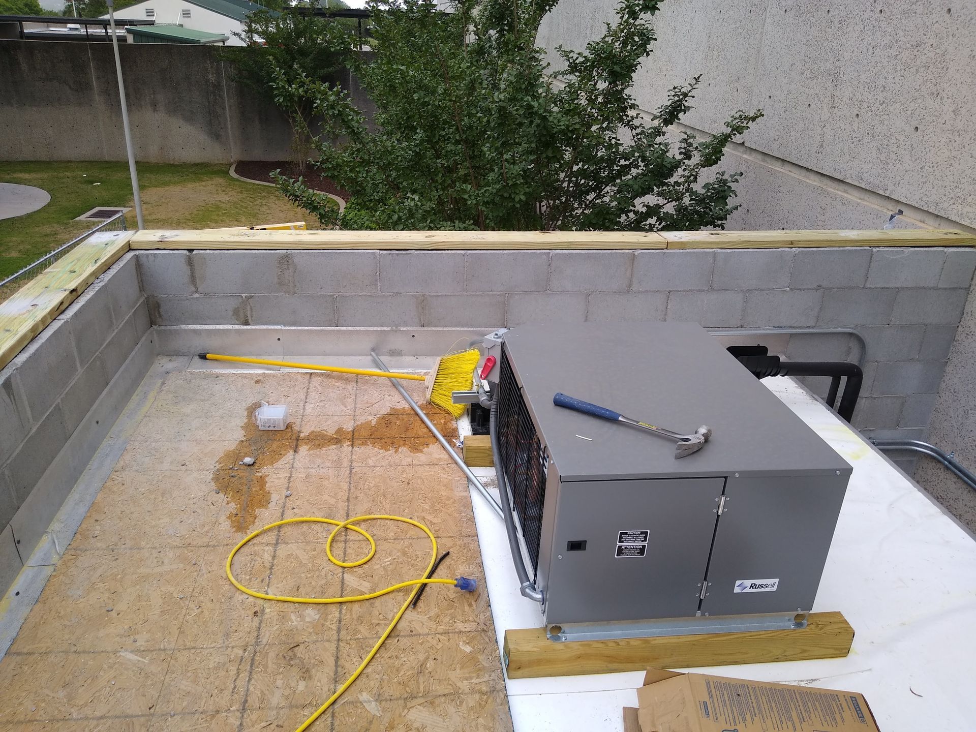 An air conditioner is sitting on top of a wooden table.