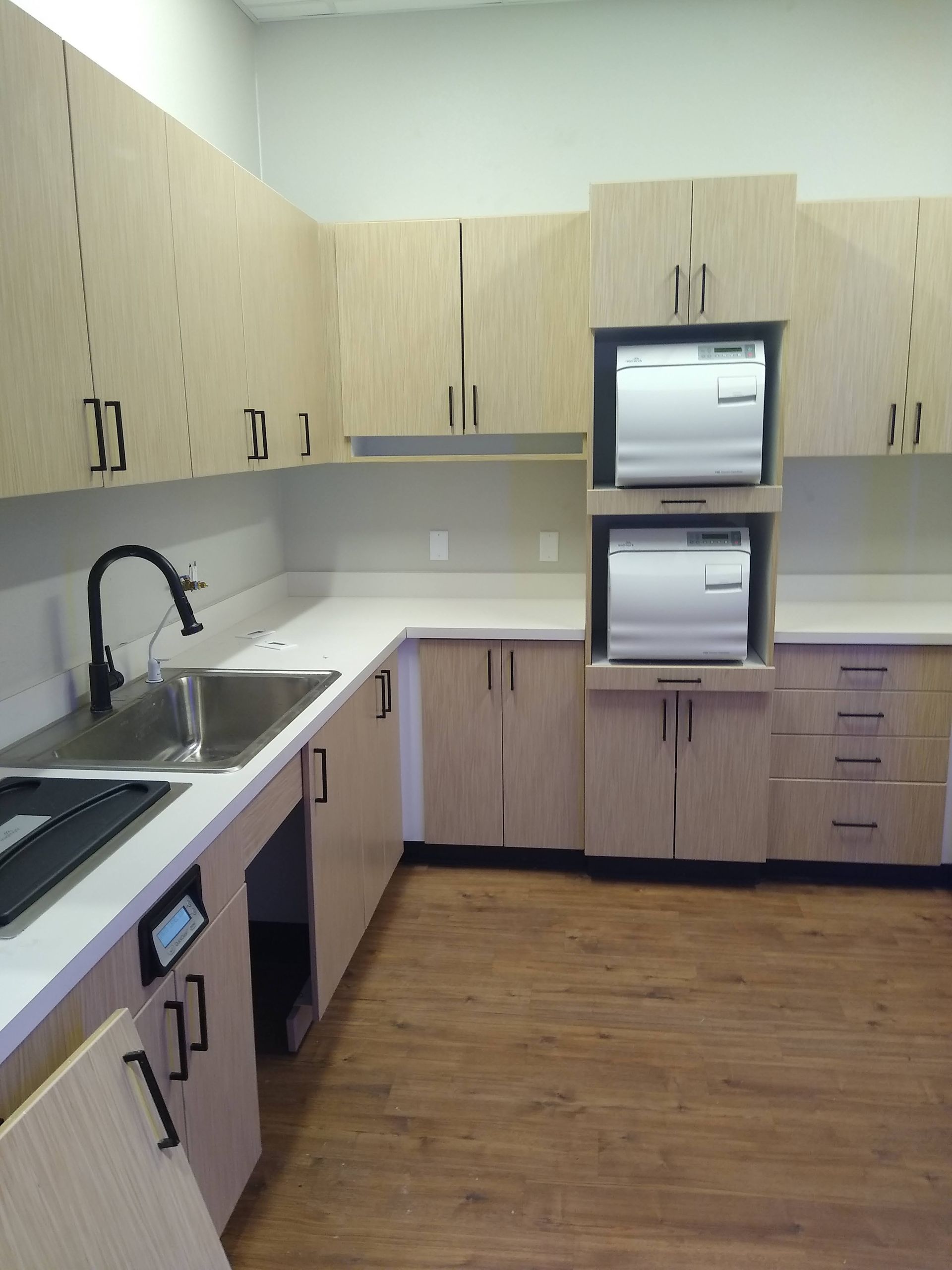 A kitchen with wooden cabinets and a sink