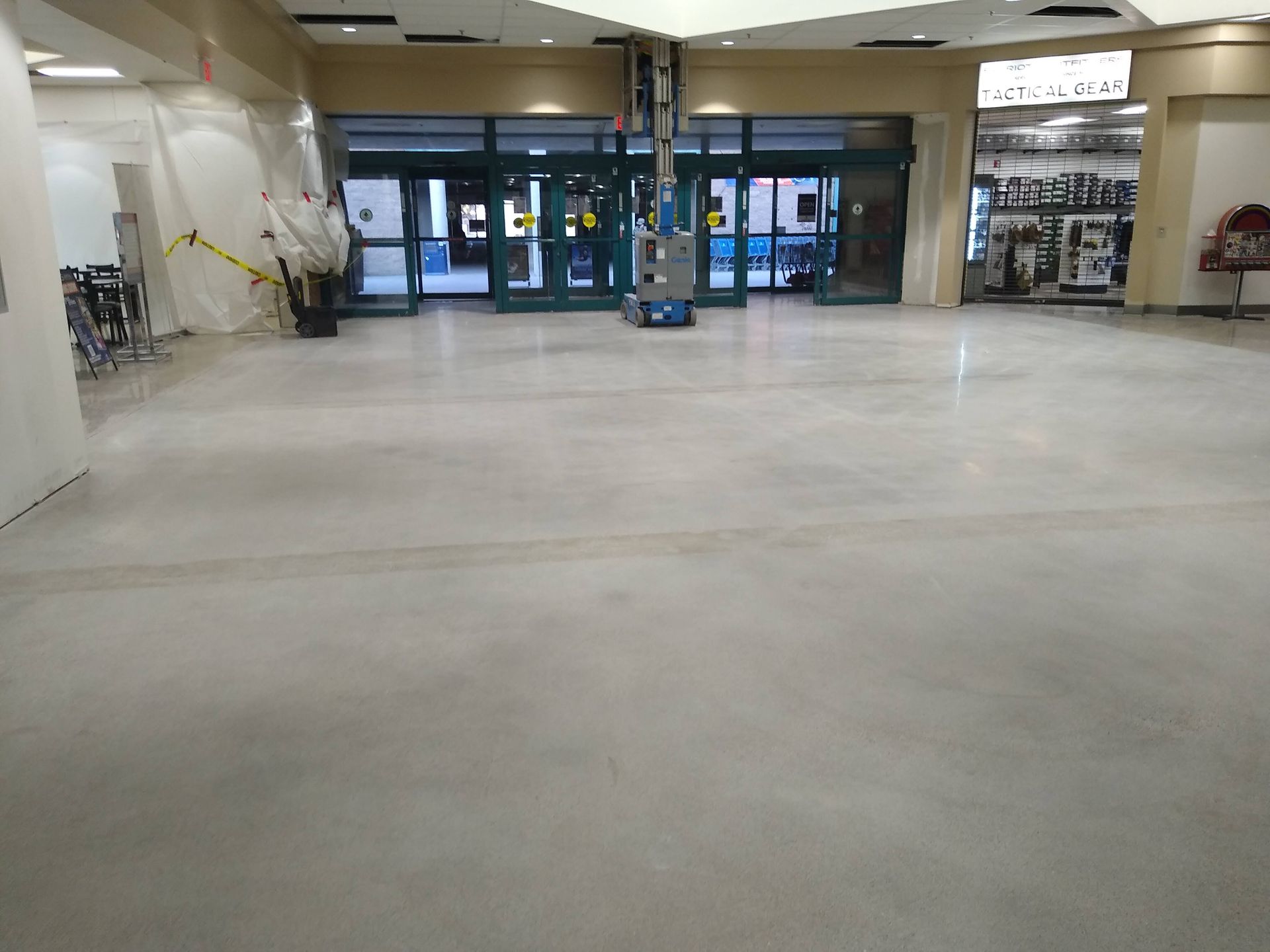 A large room with a concrete floor and a glass door