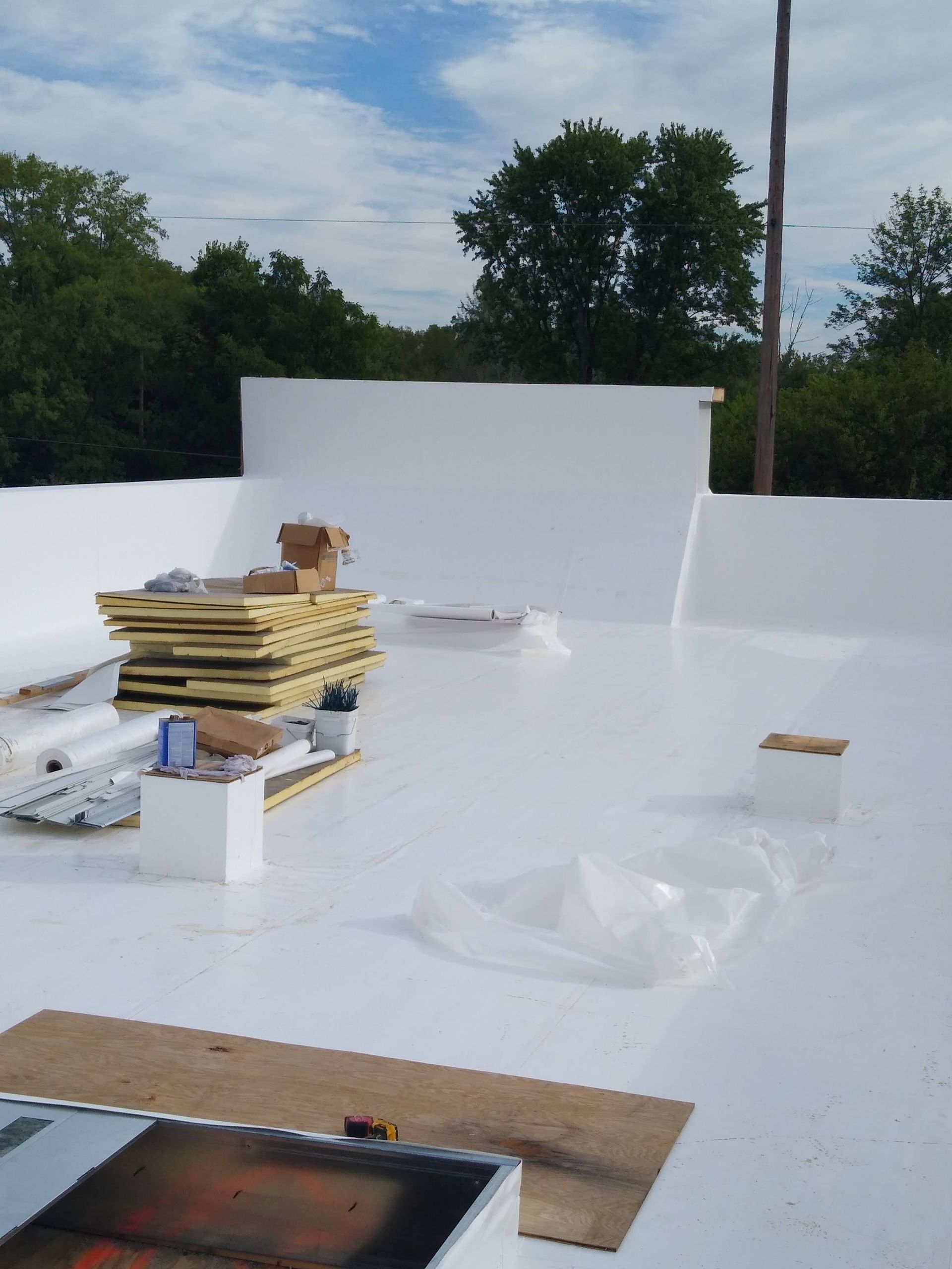 A white roof with a stack of wood on it