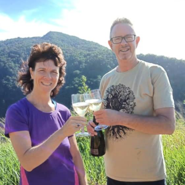 A Couple Of People Holding Drinks And Posing For A Picture — Trinity Family Chiropractic In Cairns, QLD