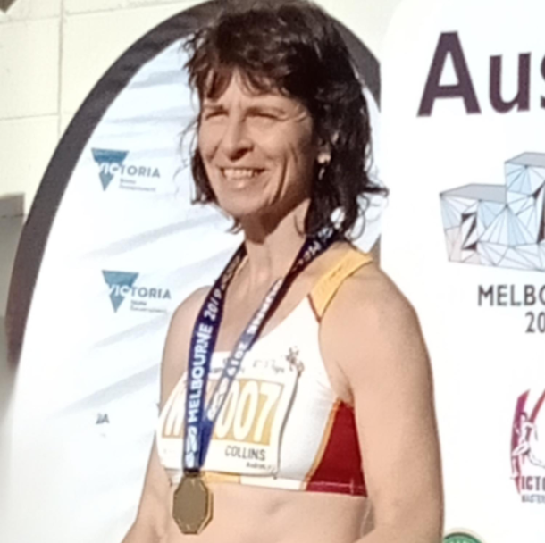 A Woman Wearing A Medal Posing For A Picture — Trinity Family Chiropractic In Cairns, QLD