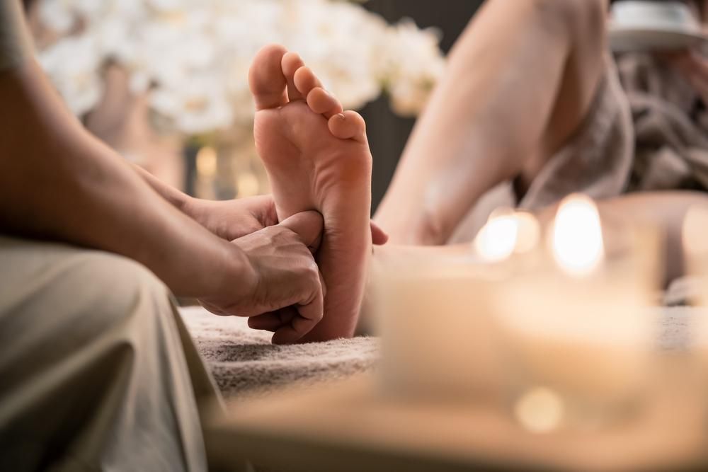 A Woman Is Getting A Foot Massage In A Spa — Trinity Family Chiropractic In Cairns, QLD