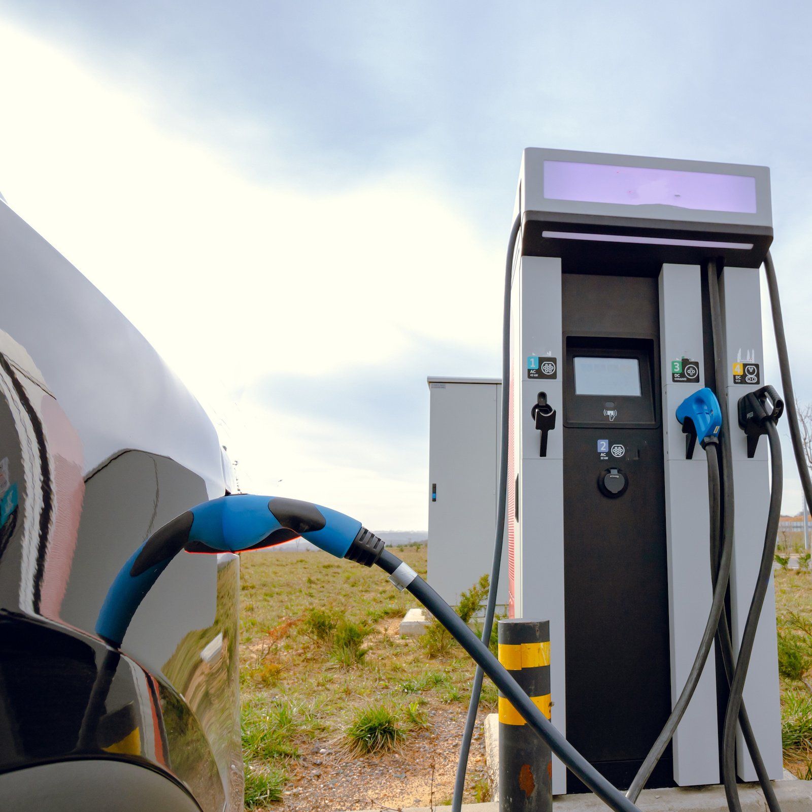 A car is being charged at a charging station