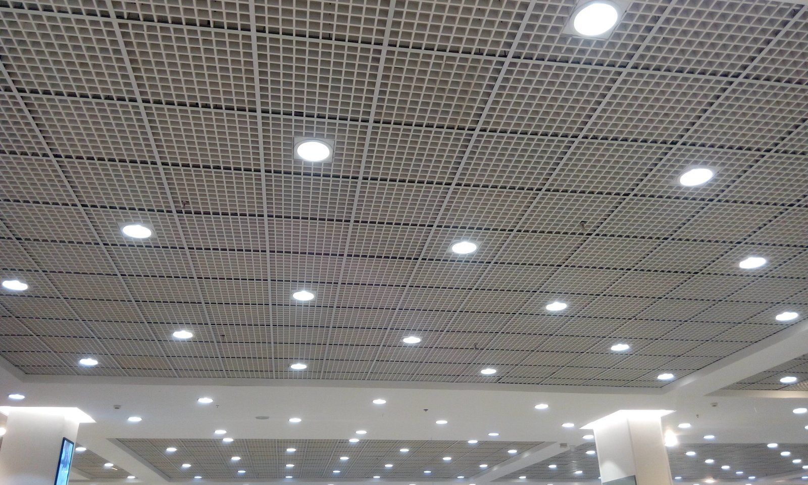 A ceiling with a lot of lights on it in a building.