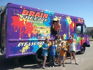 Purple Brain Freeze truck with paint splashes, six children posing beside it outdoors