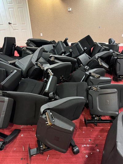 A bunch of chairs are sitting on the floor in a room.
