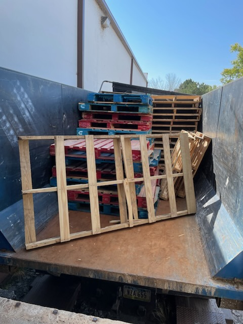 A bunch of wooden pallets are stacked on top of each other