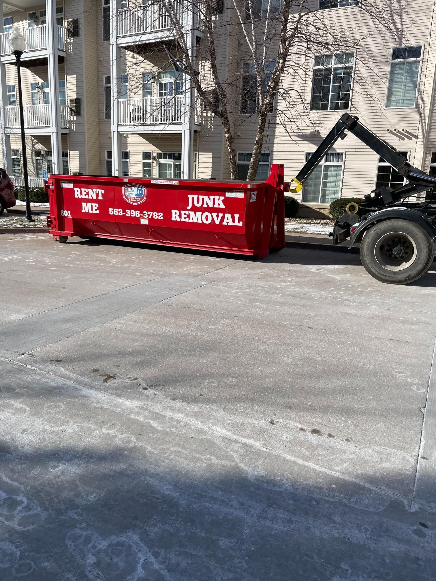 A red dumpster marked 