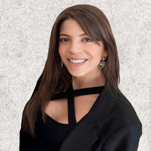 Smiling woman in black outfit against a textured light gray background