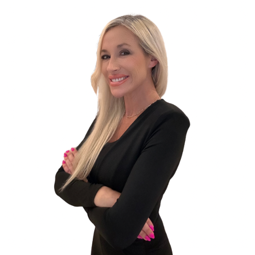 Blonde woman in a black top smiling with arms crossed against a white background